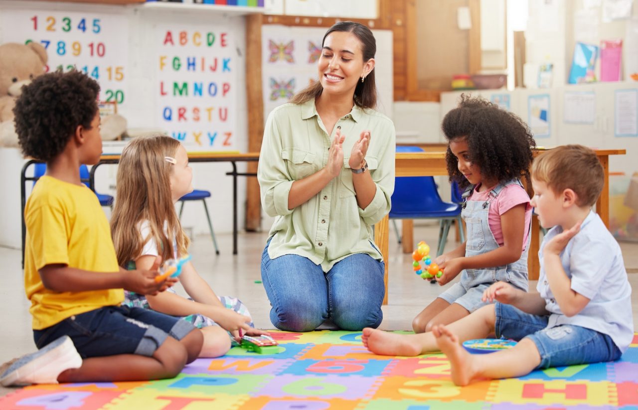 shot of a teacher singing with her preschool children